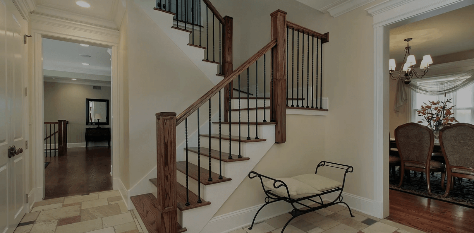 Professional interior painting for stairways and dining rooms in Denver homes Freshly painted stairwell and dining room with neutral beige walls and white trim in a Denver home