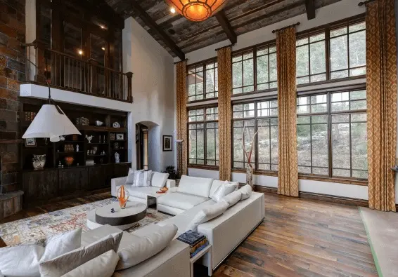 Modern rustic Denver living room with freshly painted white walls, tall windows, and wood accents